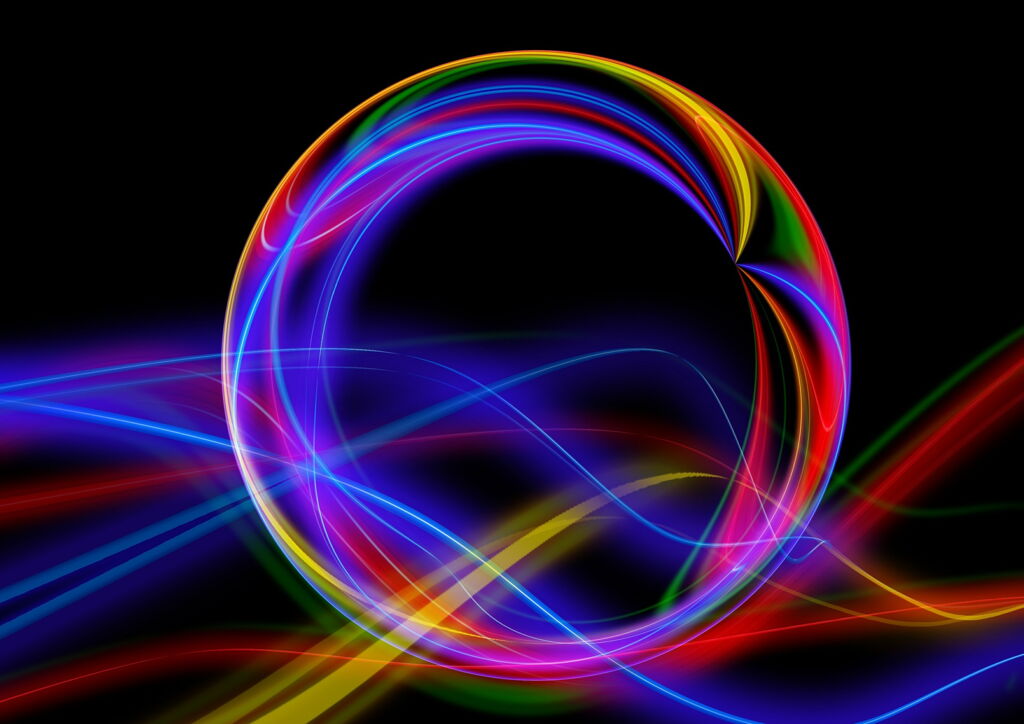 Grafik von Kreis und Wellen aus leuchtenden Grundfarben vor dunklem Hintergrund Grafik von Kreis und Wellen aus leuchtenden Grundfarben vor dunklem Hintergrund